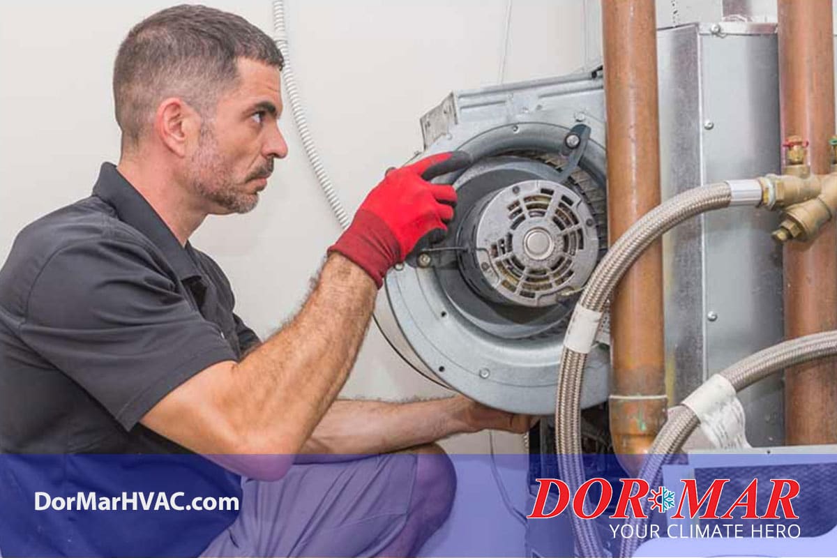 HVAC technician removing furnace blower